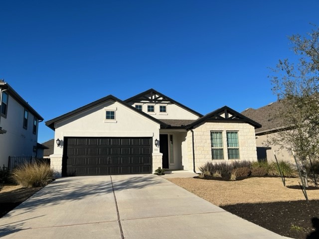 a front view of a house with a garage