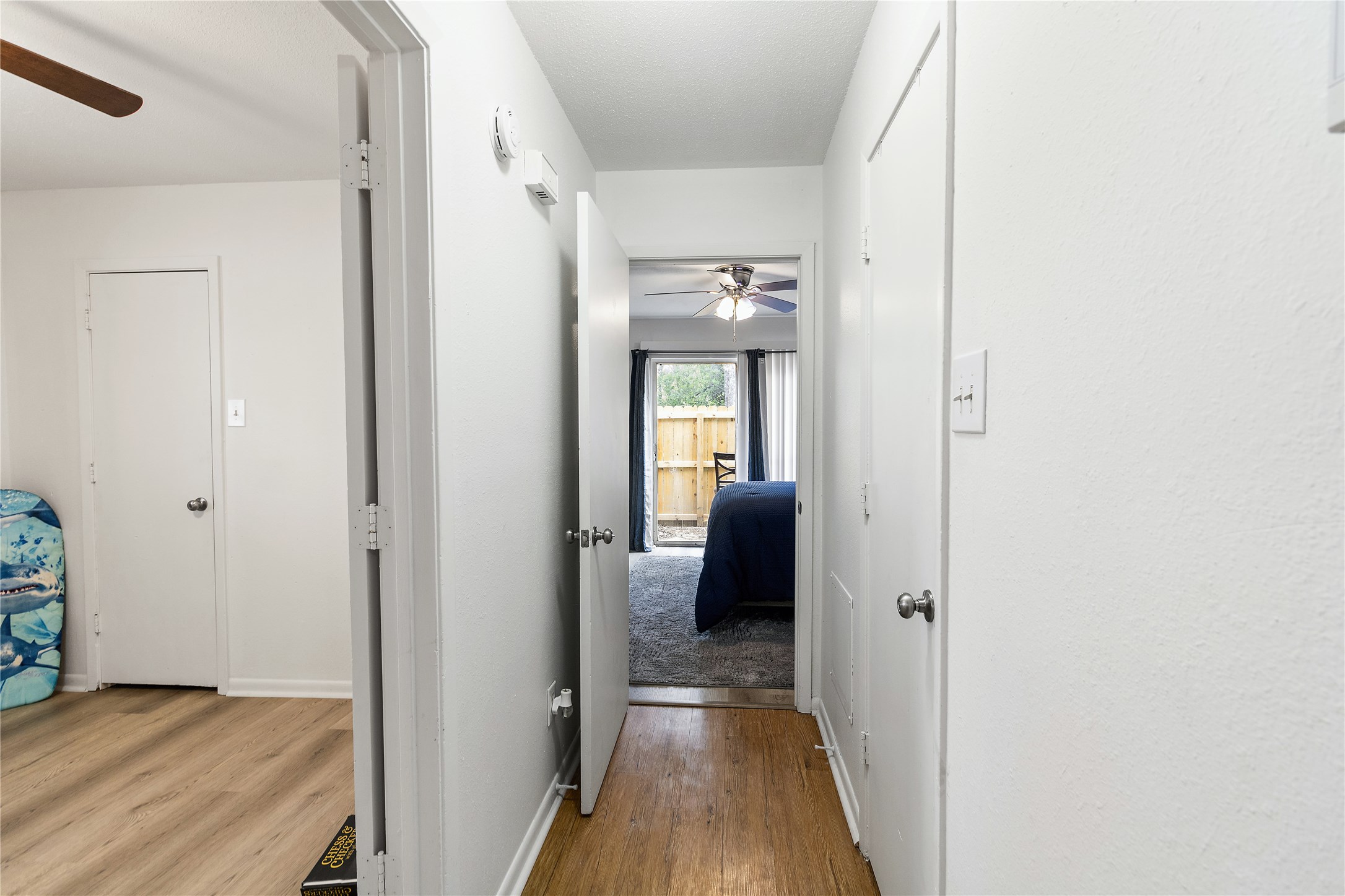 4125 Old Hearne Road Bryan, TX 77803 - Photo 11 of 21 a view of a hallway with wooden floor and a bathroom