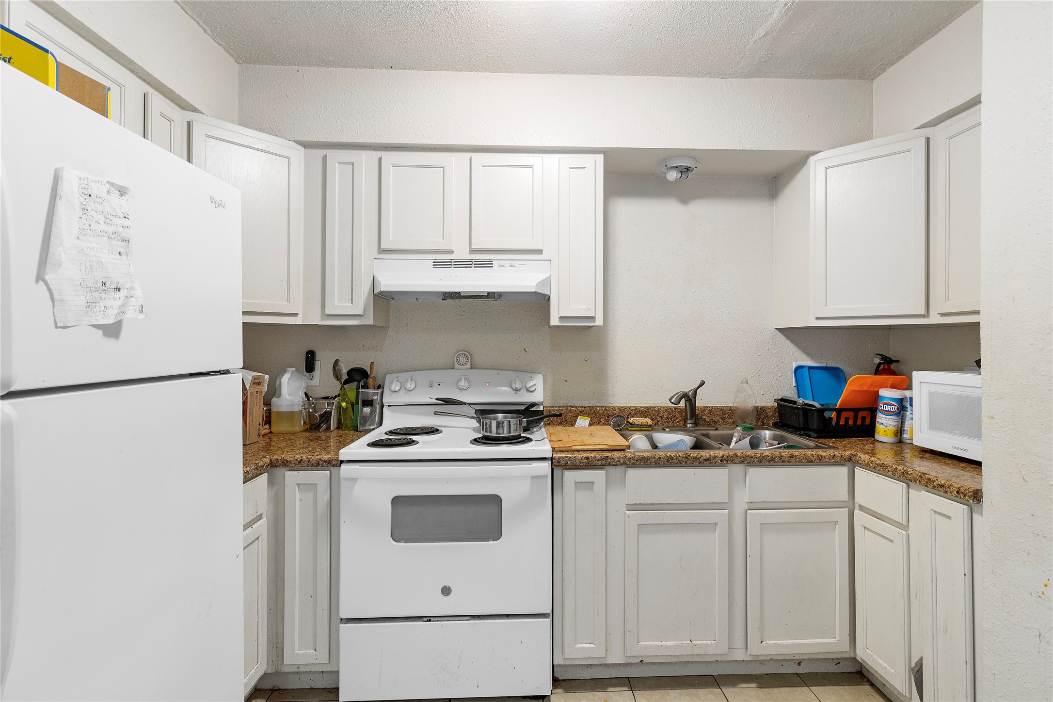 4125 Old Hearne Road Bryan, TX 77803 - Photo 14 of 21 a kitchen with white cabinets and white appliances