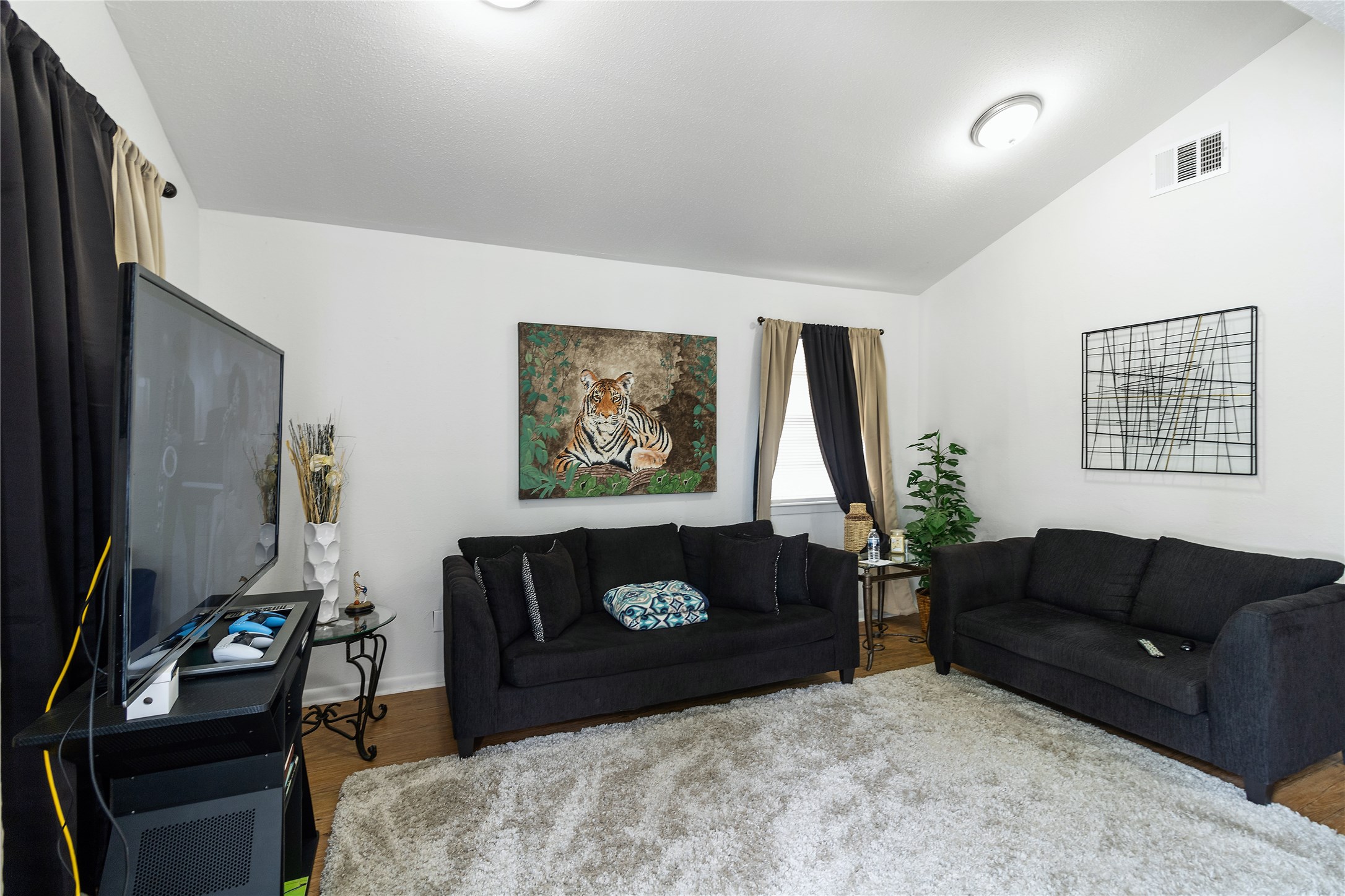 4125 Old Hearne Road Bryan, TX 77803 - Photo 2 of 21 a living room with furniture a fireplace and a flat screen tv
