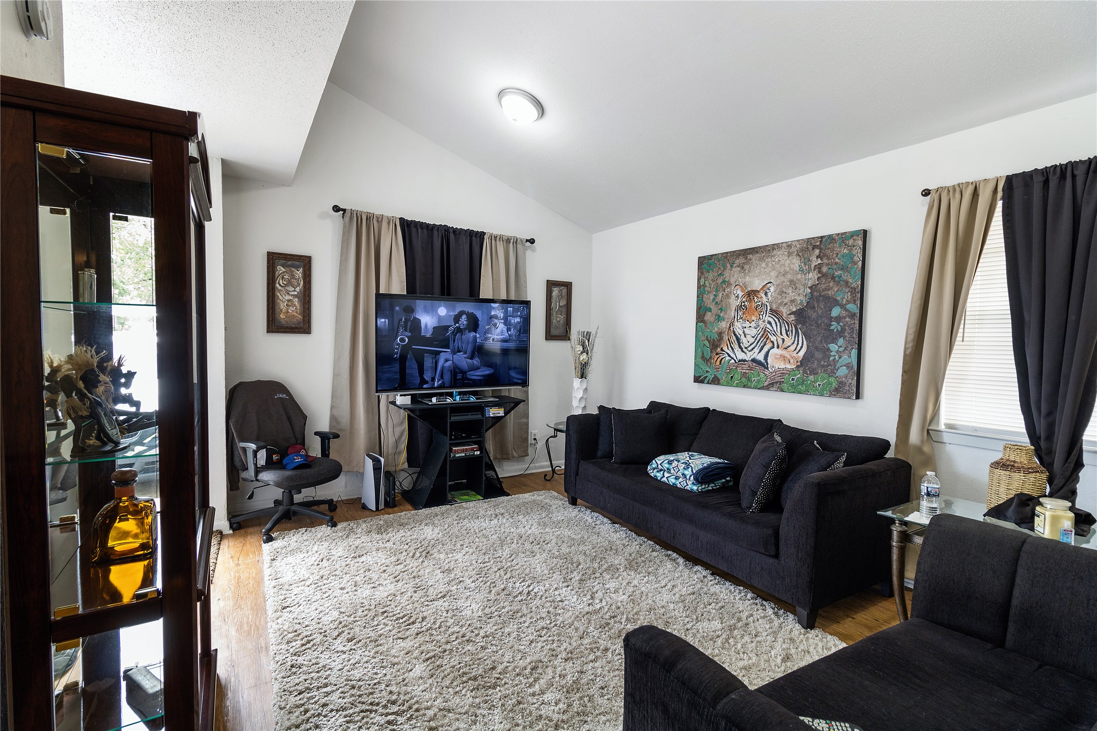 4125 Old Hearne Road Bryan, TX 77803 - Photo 3 of 21 a living room with furniture a flat screen tv and a fireplace