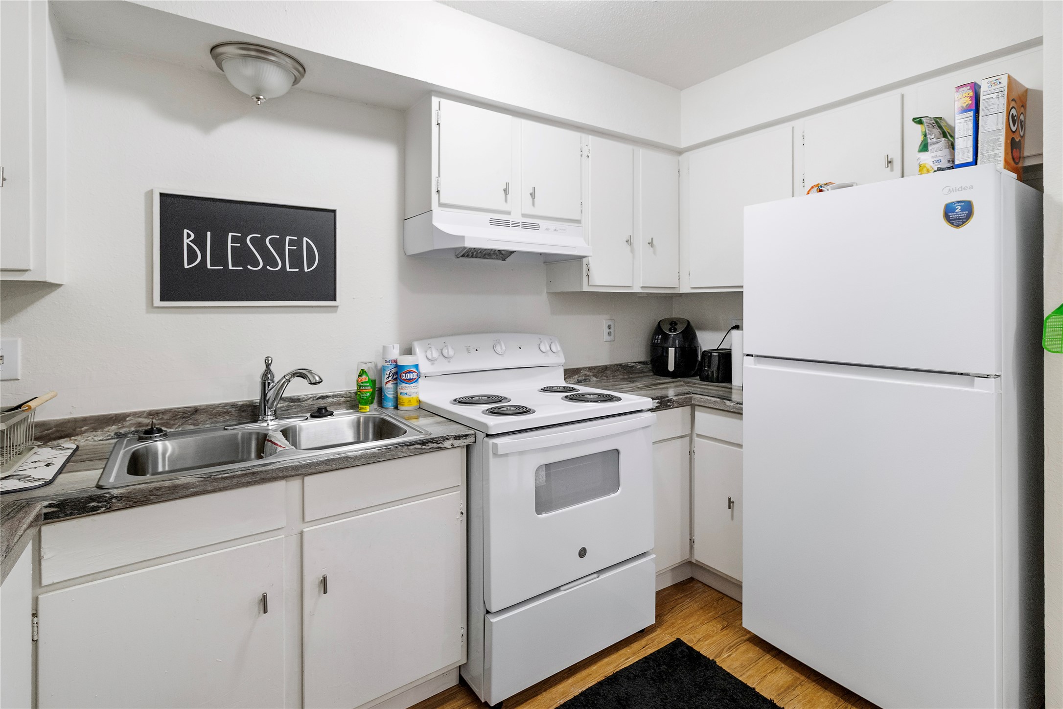4125 Old Hearne Road Bryan, TX 77803 - Photo 5 of 21 a kitchen with a sink a refrigerator and cabinets