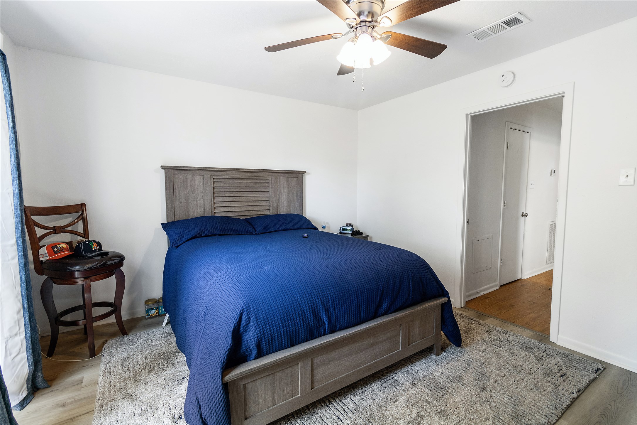 4125 Old Hearne Road Bryan, TX 77803 - Photo 10 of 21 a bedroom with a bed and a chandelier