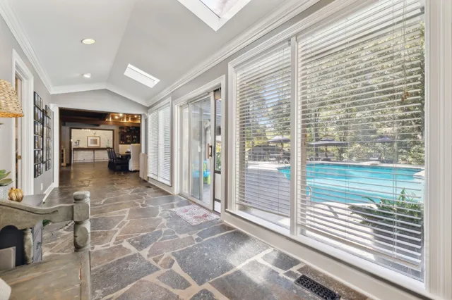 a view of a bathroom with a granite countertop a sink a stove a mirror and glass door