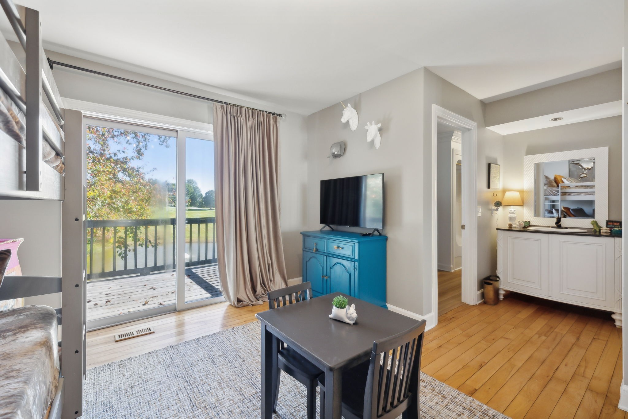 1985 Country View Chapmansboro, TN 37035 - Photo 48 of 88 a living room with furniture a flat screen tv and a floor to ceiling window