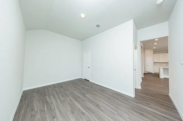a view of a room with wooden floor