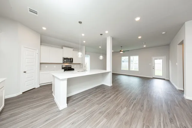 a view of kitchen with sink and wooden floor
