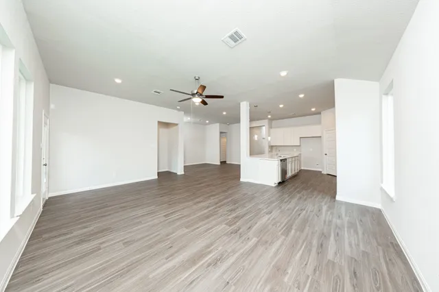 a view of kitchen and hall with wooden floor
