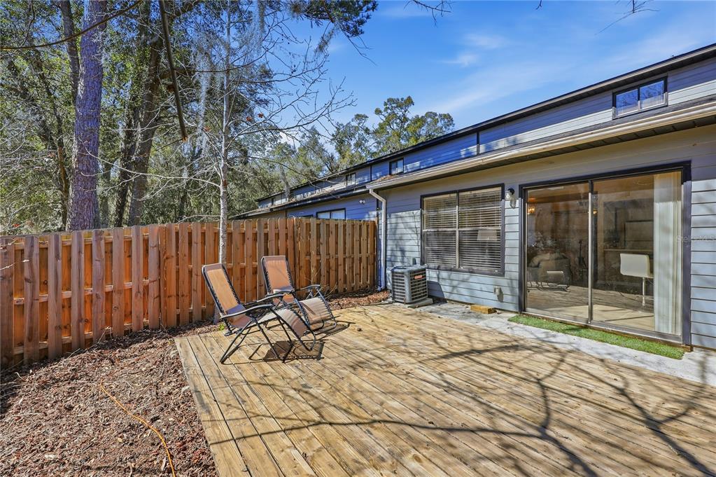 4427 Southwest 21st Lane Gainesville, FL 32607 - Photo 7 of 36 a view of backyard with a patio and wooden fence