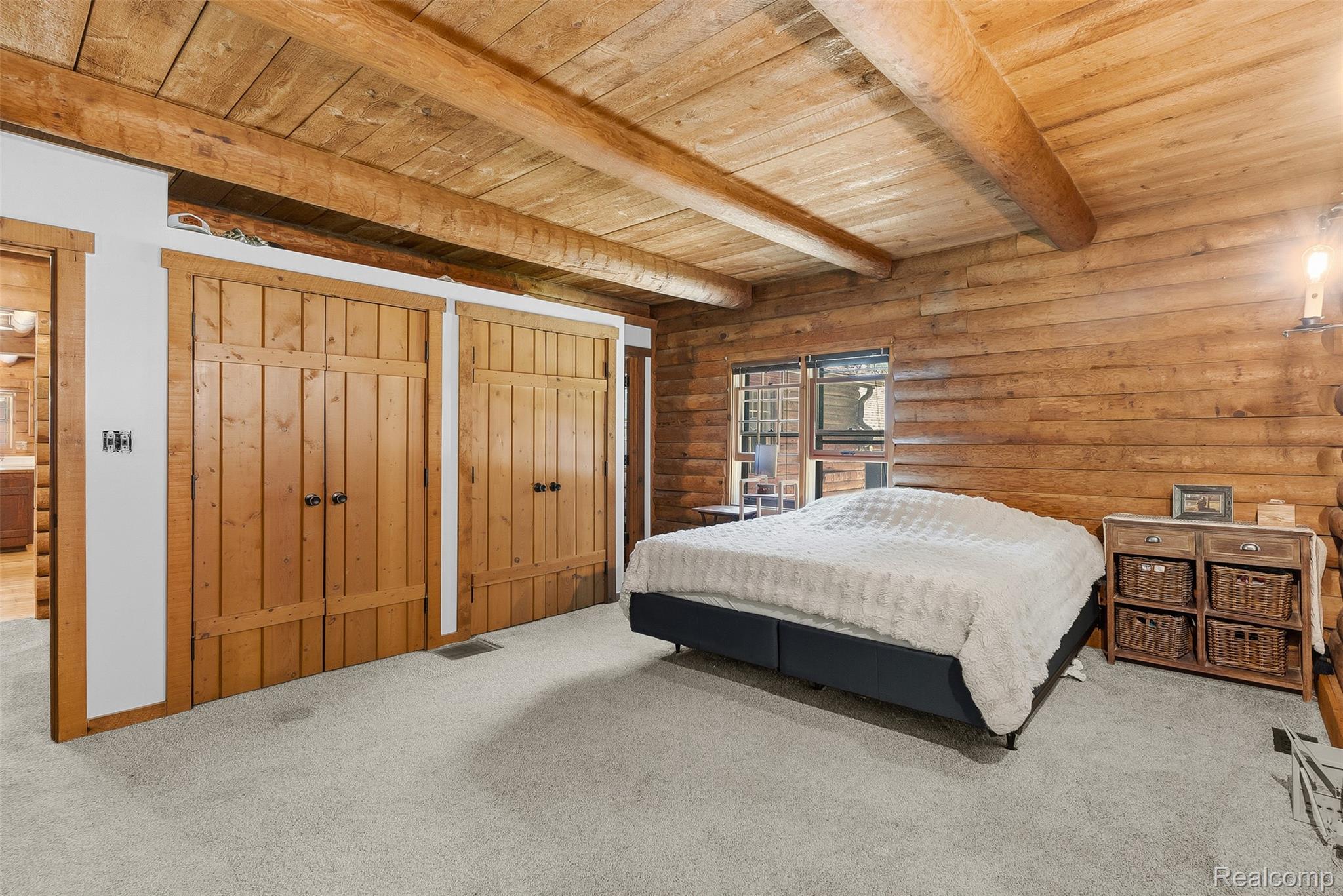 3656 Stanley Road Columbiaville, MI 48421 - Photo 20 of 65 Timber-framed room featuring natural wood log walls and exposed log beams