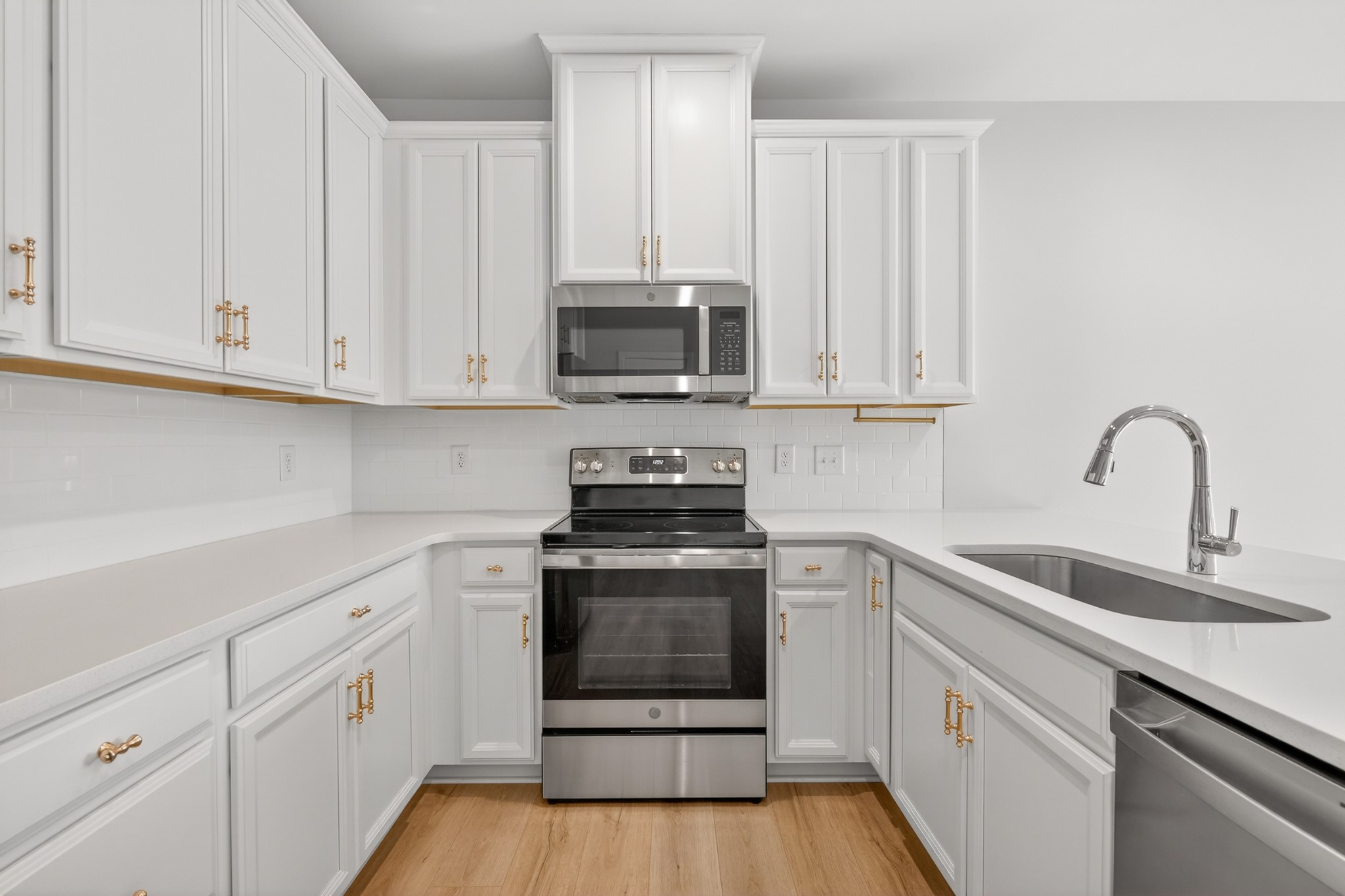 1085 Duncan Street Gallatin, TN 37066 - Photo 11 of 35 a kitchen with white cabinets and stainless steel appliances