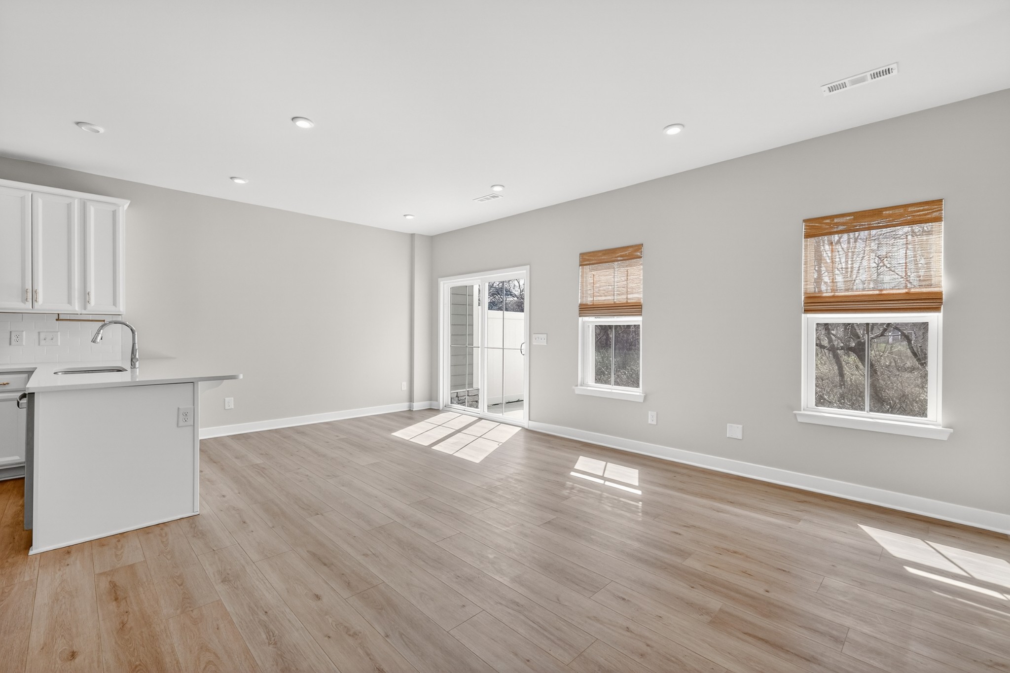 1085 Duncan Street Gallatin, TN 37066 - Photo 12 of 35 a view of an empty room with wooden floor and a window