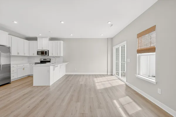 a kitchen with granite countertop white cabinets and white appliances
