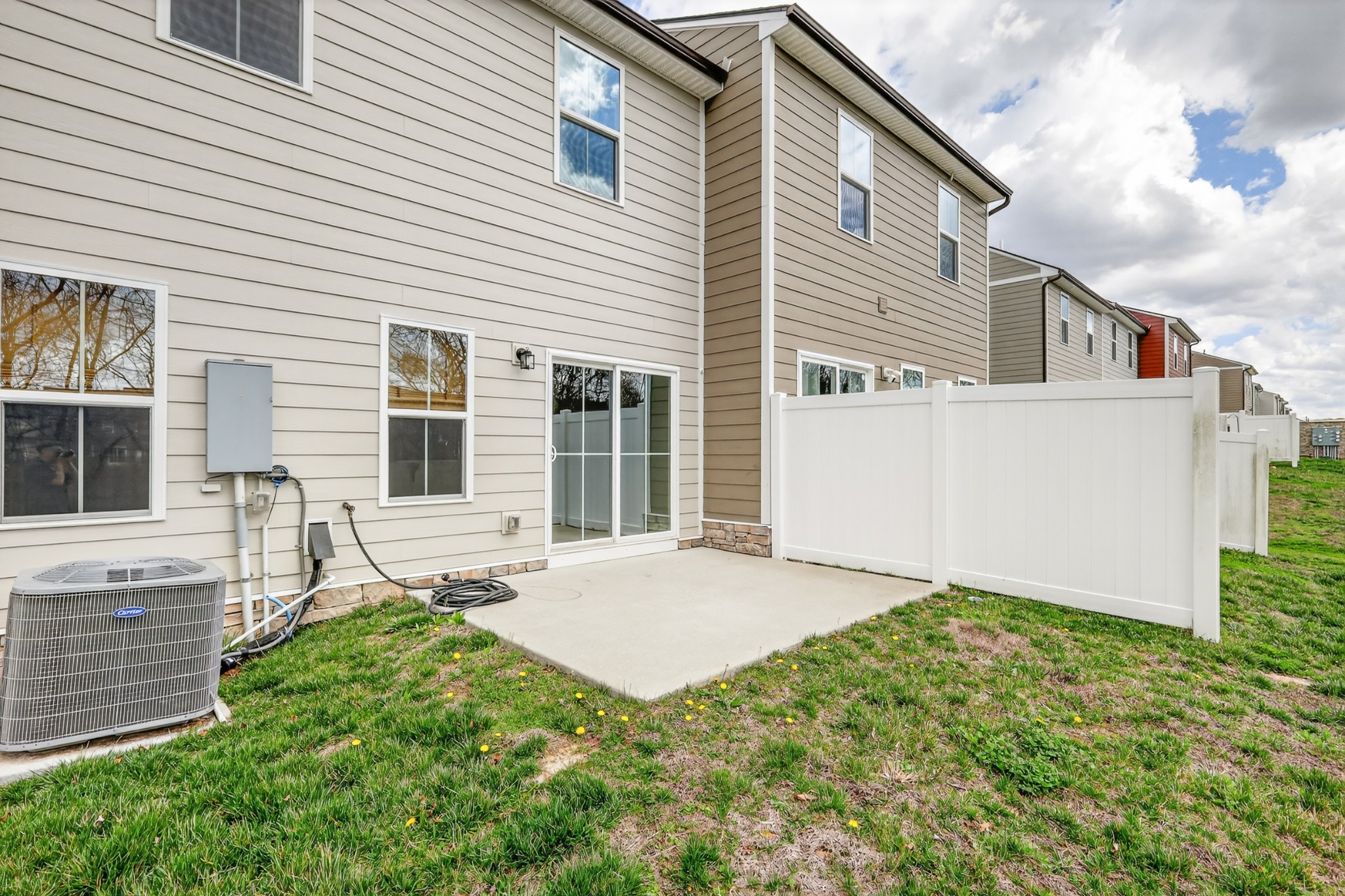 1085 Duncan Street Gallatin, TN 37066 - Photo 35 of 35 a backyard of a white house with potted plants and a table and chairs