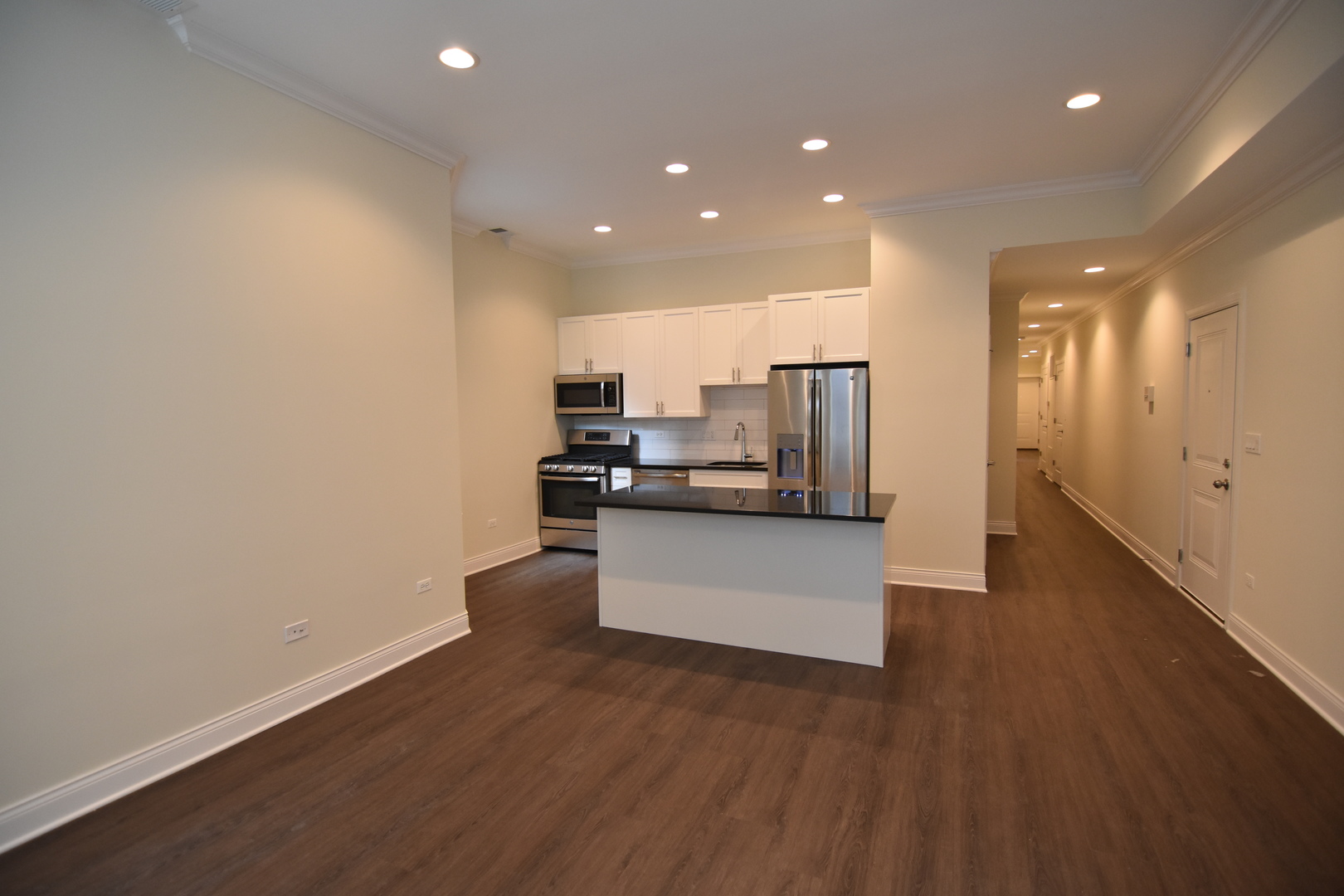 Undisclosed Address Chicago, IL 60657 - Photo 2 of 18 a view of kitchen with kitchen island stainless steel appliances counter space and wooden floor