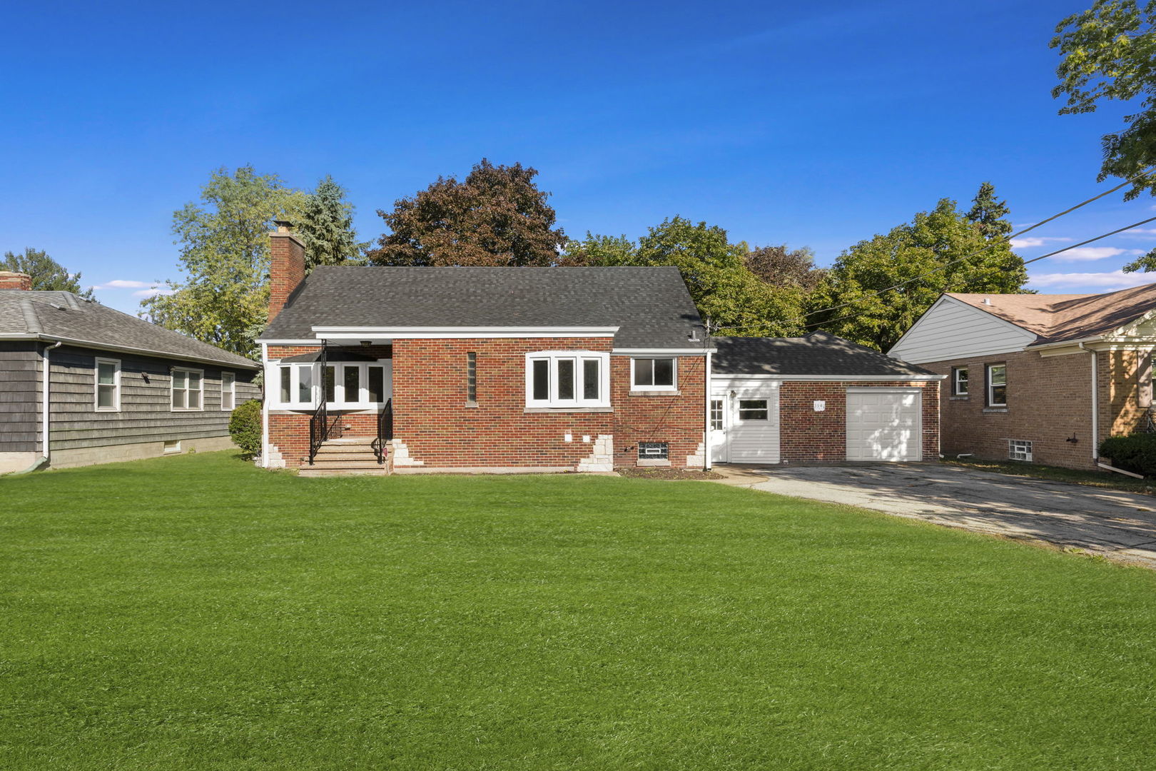 a front view of a house with a garden