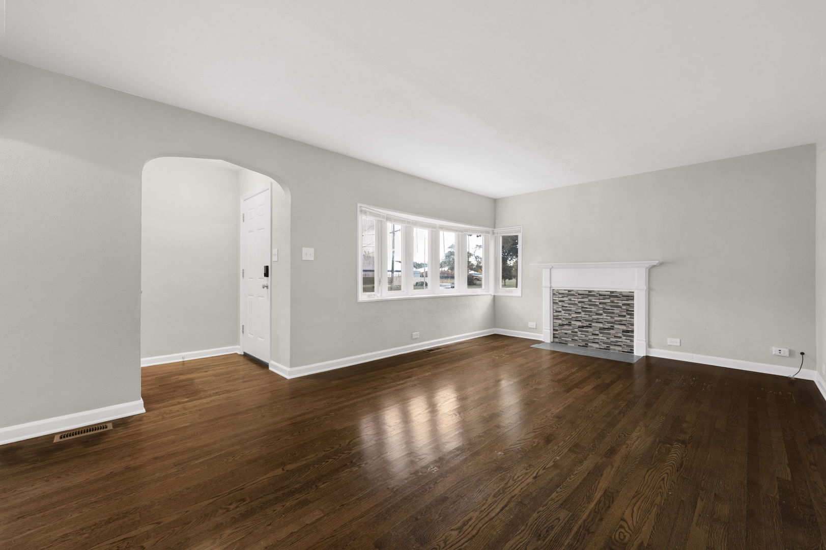 3540 Bernice Road Lansing, IL 60438 - Photo 2 of 17 a view of an empty room with wooden floor and a window
