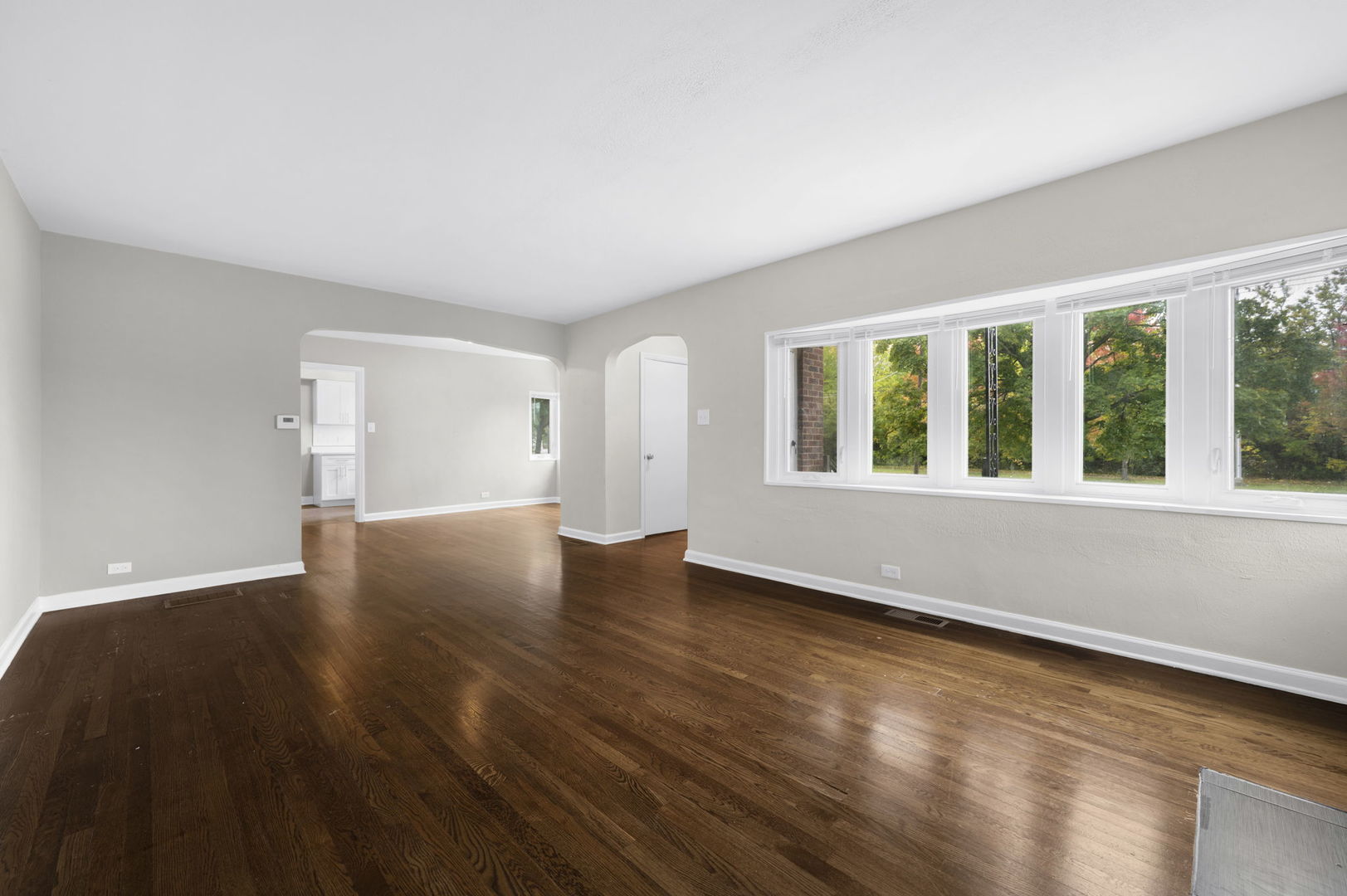 3540 Bernice Road Lansing, IL 60438 - Photo 3 of 17 a view of an empty room with wooden floor and a window