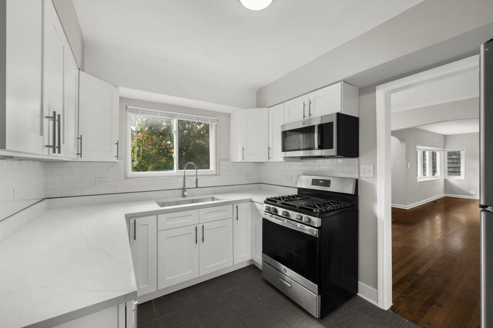 3540 Bernice Road Lansing, IL 60438 - Photo 5 of 17 a kitchen with granite countertop a stove a sink and a microwave