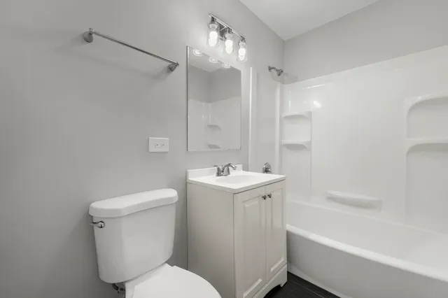 a bathroom with a sink toilet tub and shower