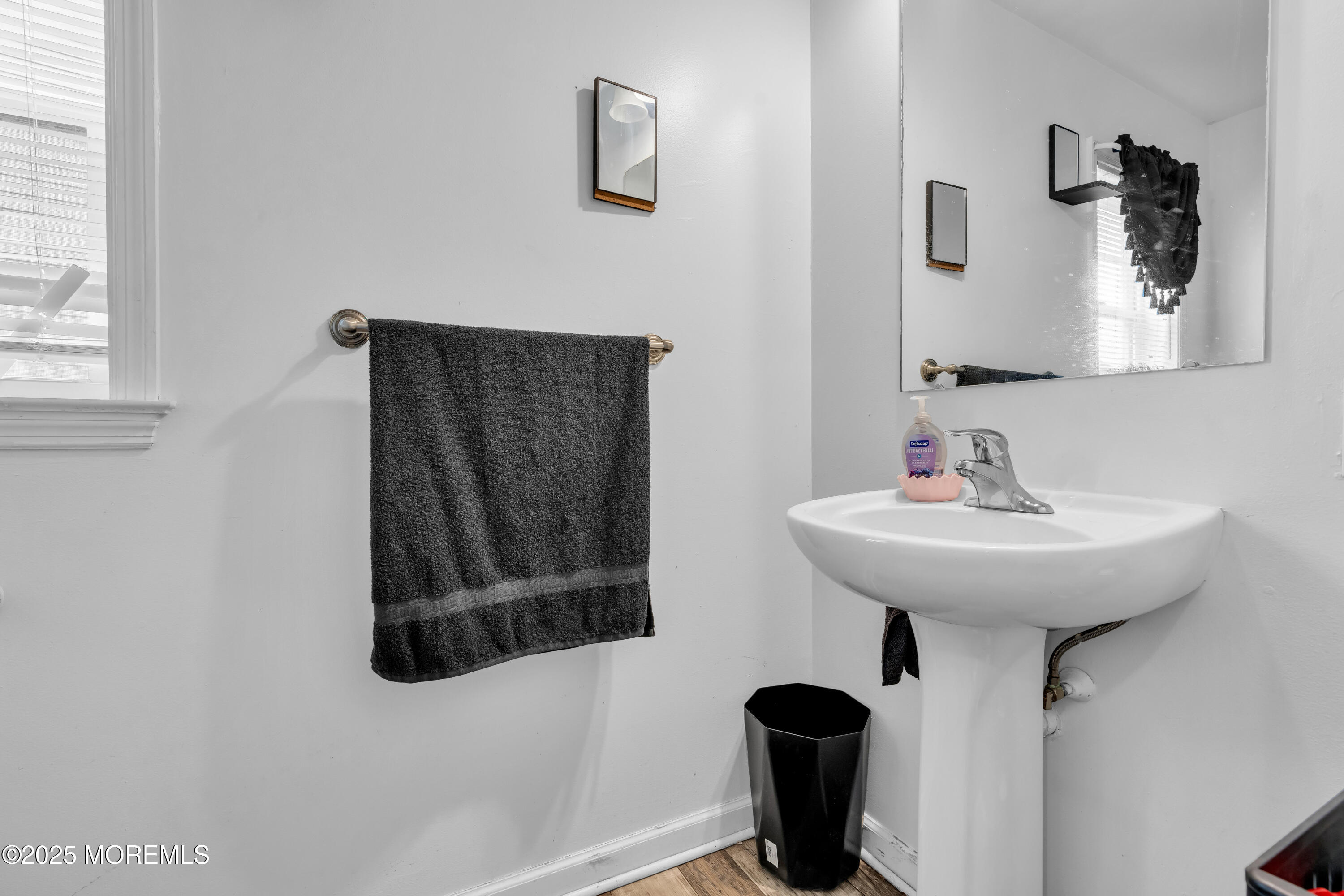 152 Myrtle Avenue Neptune Township, NJ 07753 - Photo 10 of 12 a bathroom with a sink and a mirror
