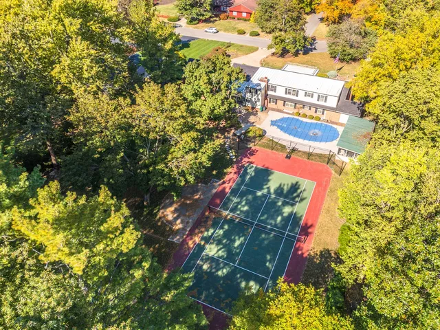 an aerial view of residential house with outdoor space and swimming pool