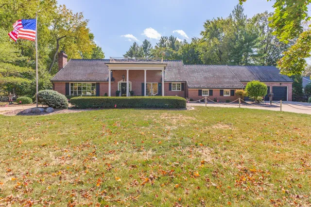 an aerial view of a house with a yard swimming pool and outdoor seating