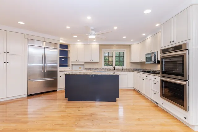 a view of an empty room with cabinet and a window
