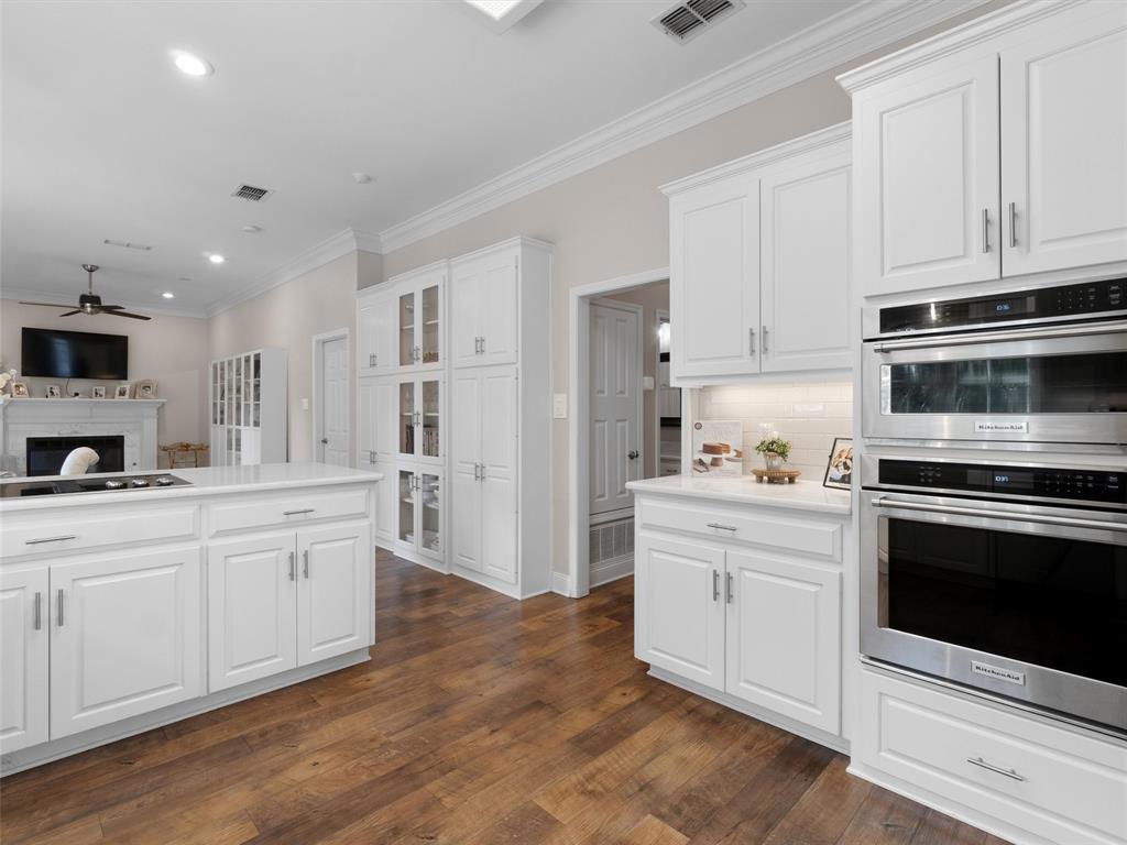 1103 Marigold Lane Longview, TX 75604 - Photo 11 of 34 a kitchen with granite countertop white cabinets and stainless steel appliances