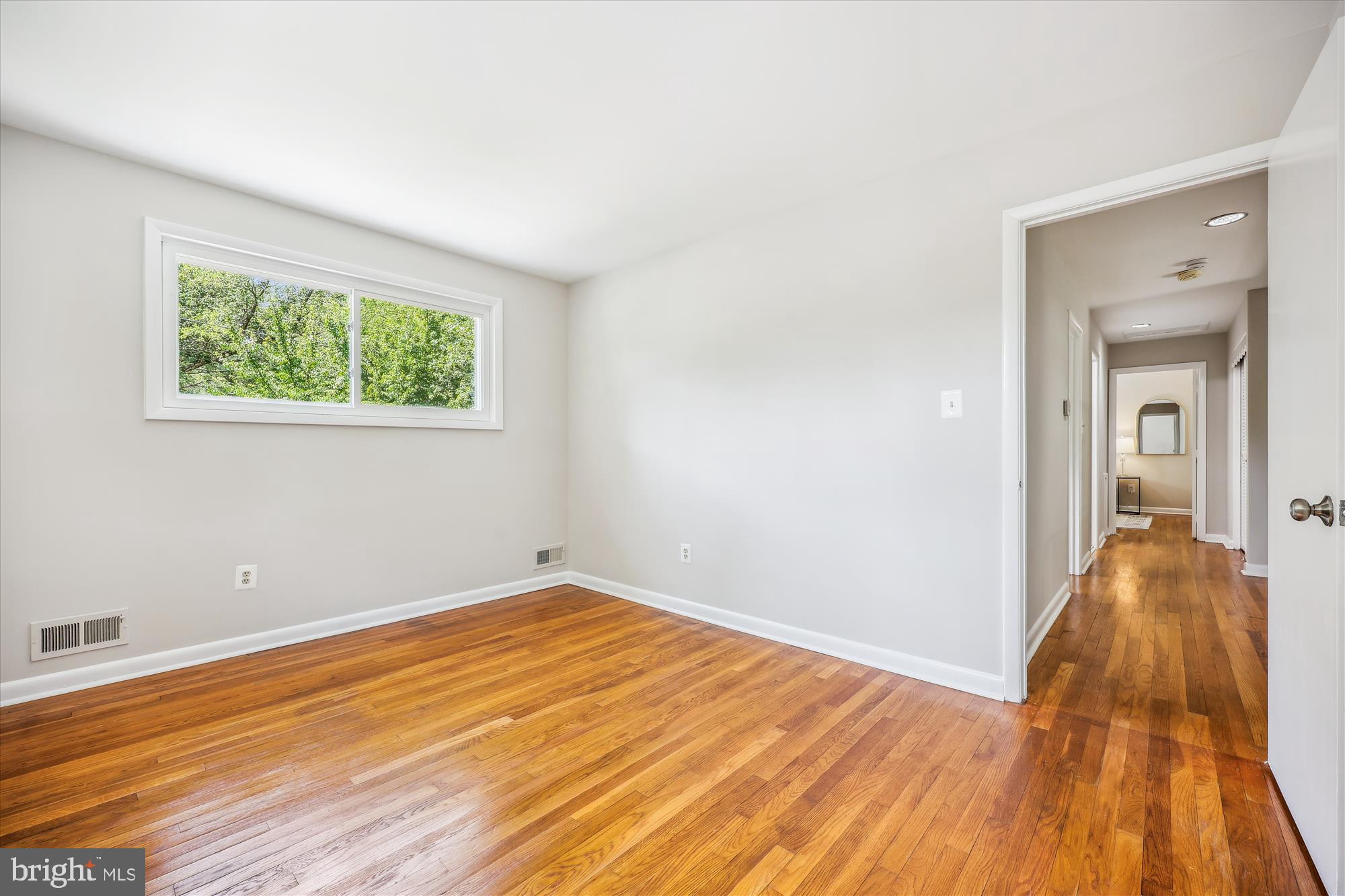 905 Kenbrook Drive Silver Spring, MD 20902 - Photo 32 of 47 a view of a room with wooden floor and a window