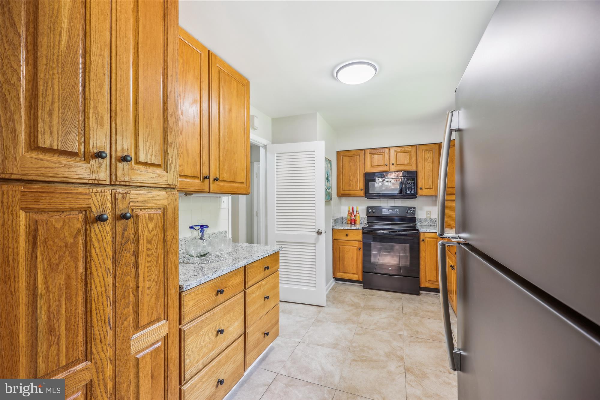905 Kenbrook Drive Silver Spring, MD 20902 - Photo 7 of 47 a kitchen with stainless steel appliances a refrigerator and cabinets