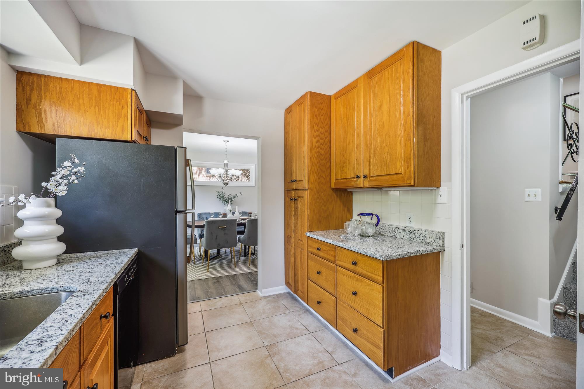 905 Kenbrook Drive Silver Spring, MD 20902 - Photo 9 of 47 a kitchen with stainless steel appliances granite countertop a stove a sink and a microwave