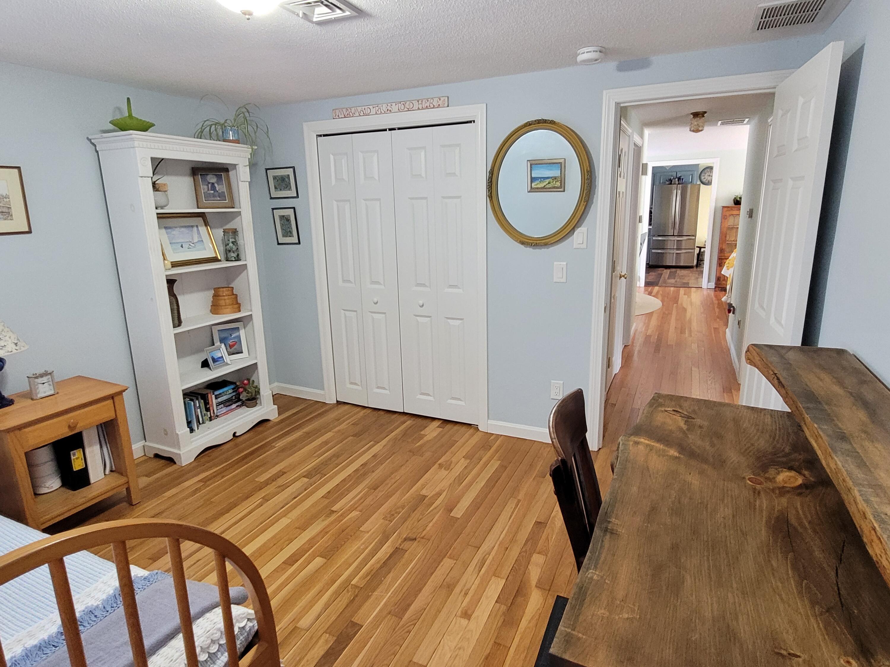 70 Trowbridge Path West Yarmouth, MA 02673 - Photo 23 of 69 a bedroom with a bed and a bookshelf with wooden floor
