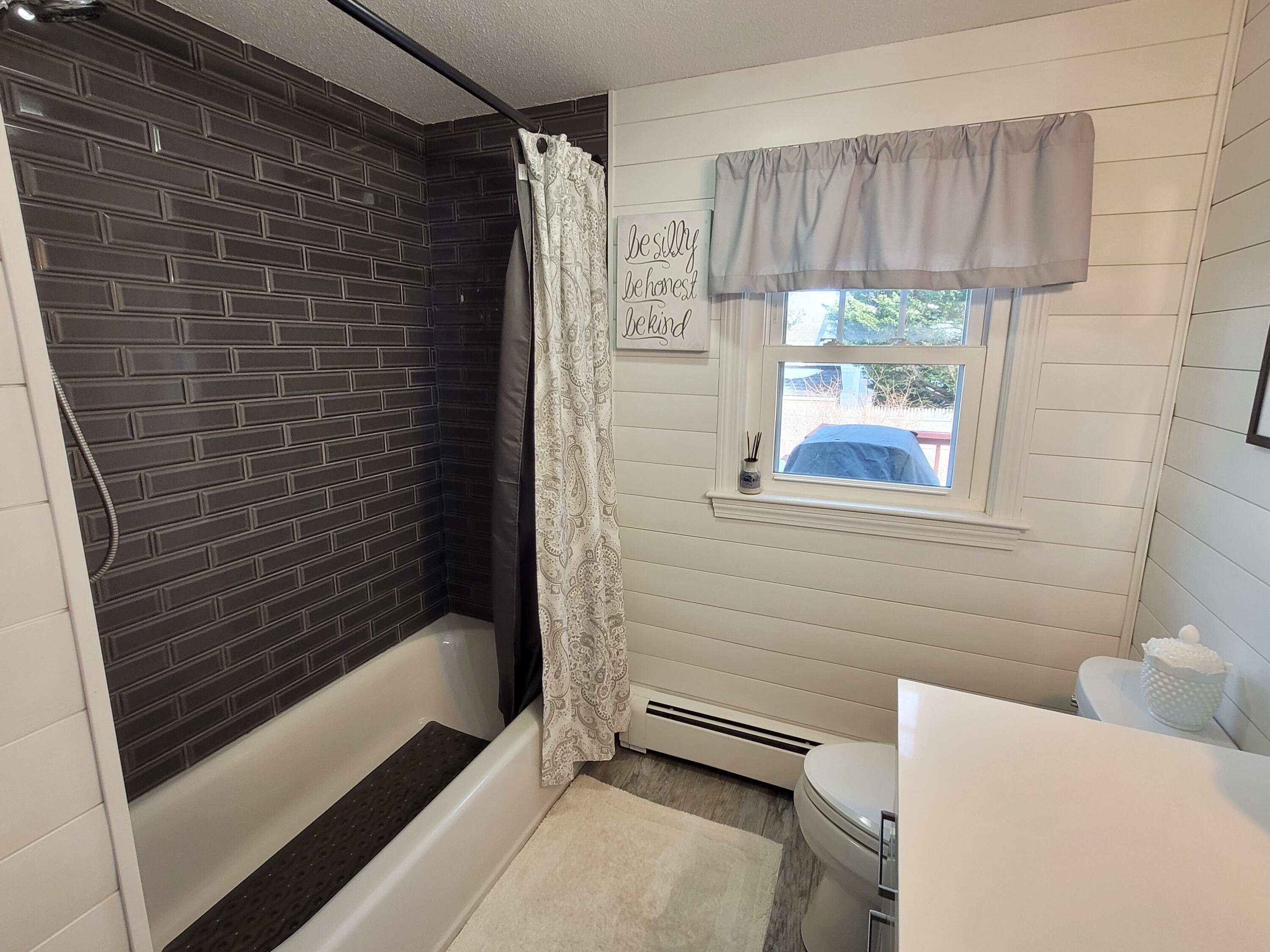 70 Trowbridge Path West Yarmouth, MA 02673 - Photo 26 of 69 a bathroom with a bathtub and a shower