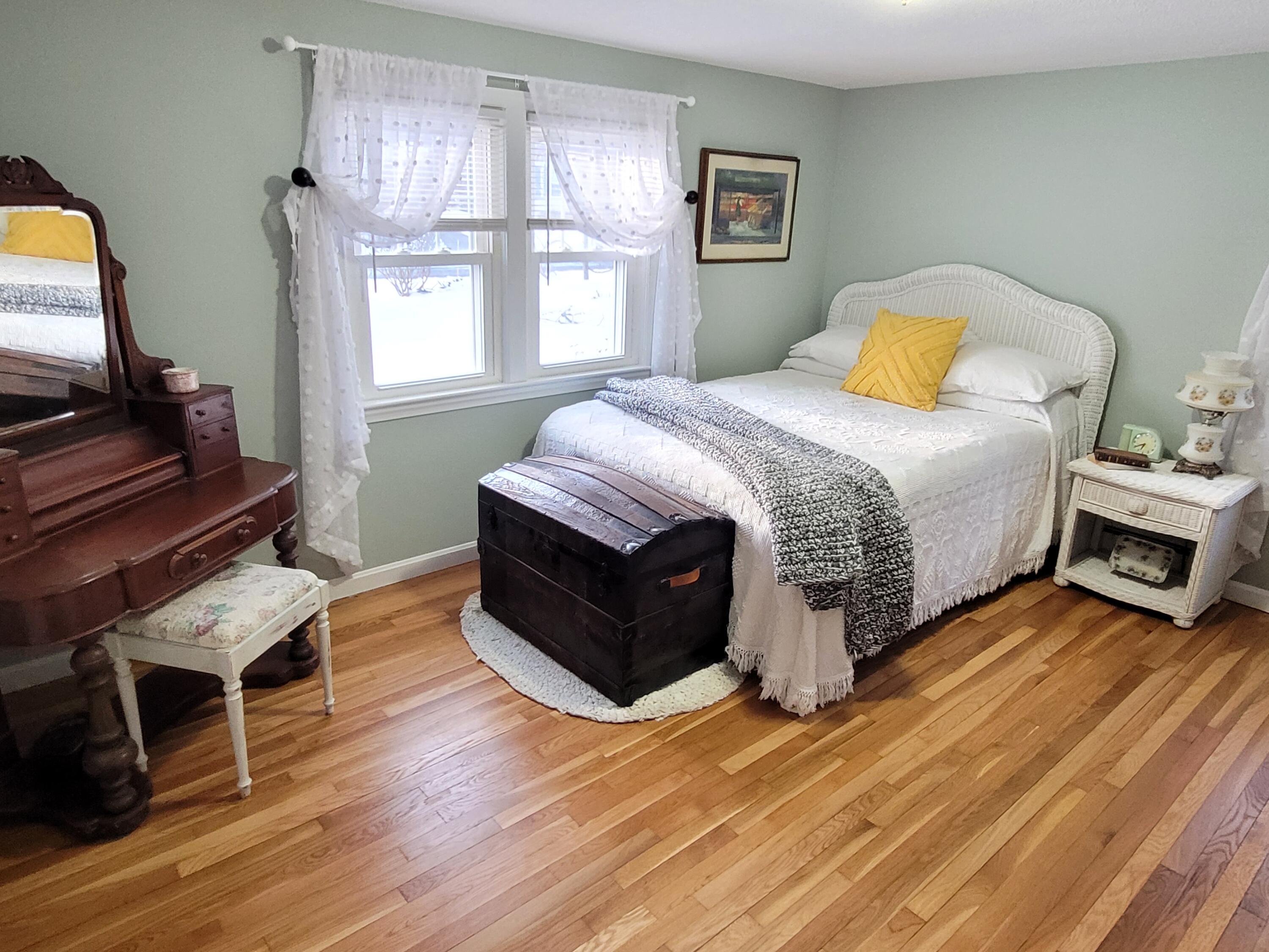 70 Trowbridge Path West Yarmouth, MA 02673 - Photo 27 of 69 a bedroom with a bed and wooden floor