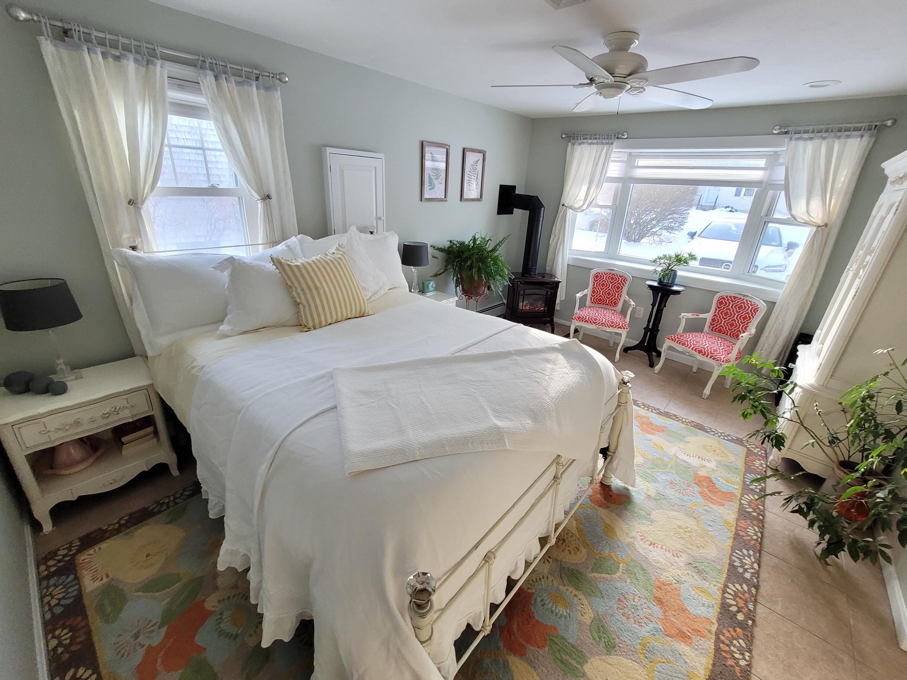 70 Trowbridge Path West Yarmouth, MA 02673 - Photo 33 of 69 a spacious bedroom with a bed table closet and a window