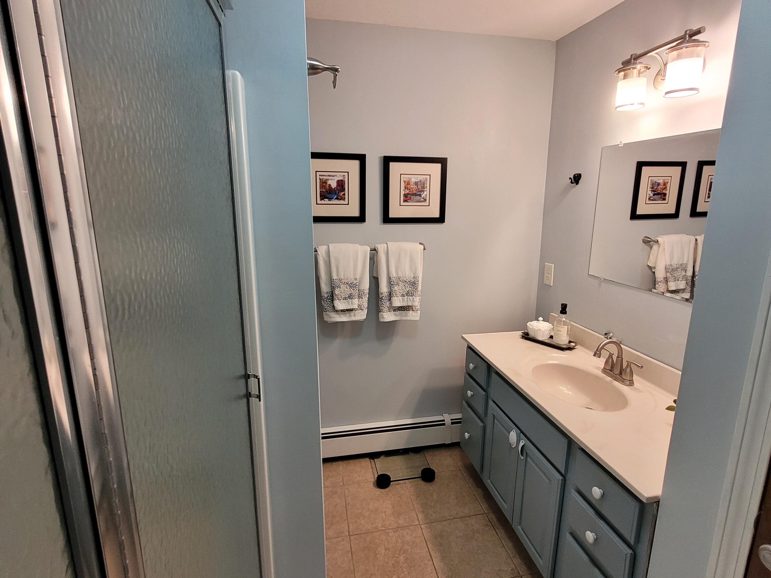 70 Trowbridge Path West Yarmouth, MA 02673 - Photo 35 of 69 a bathroom with a sink a mirror and a shower