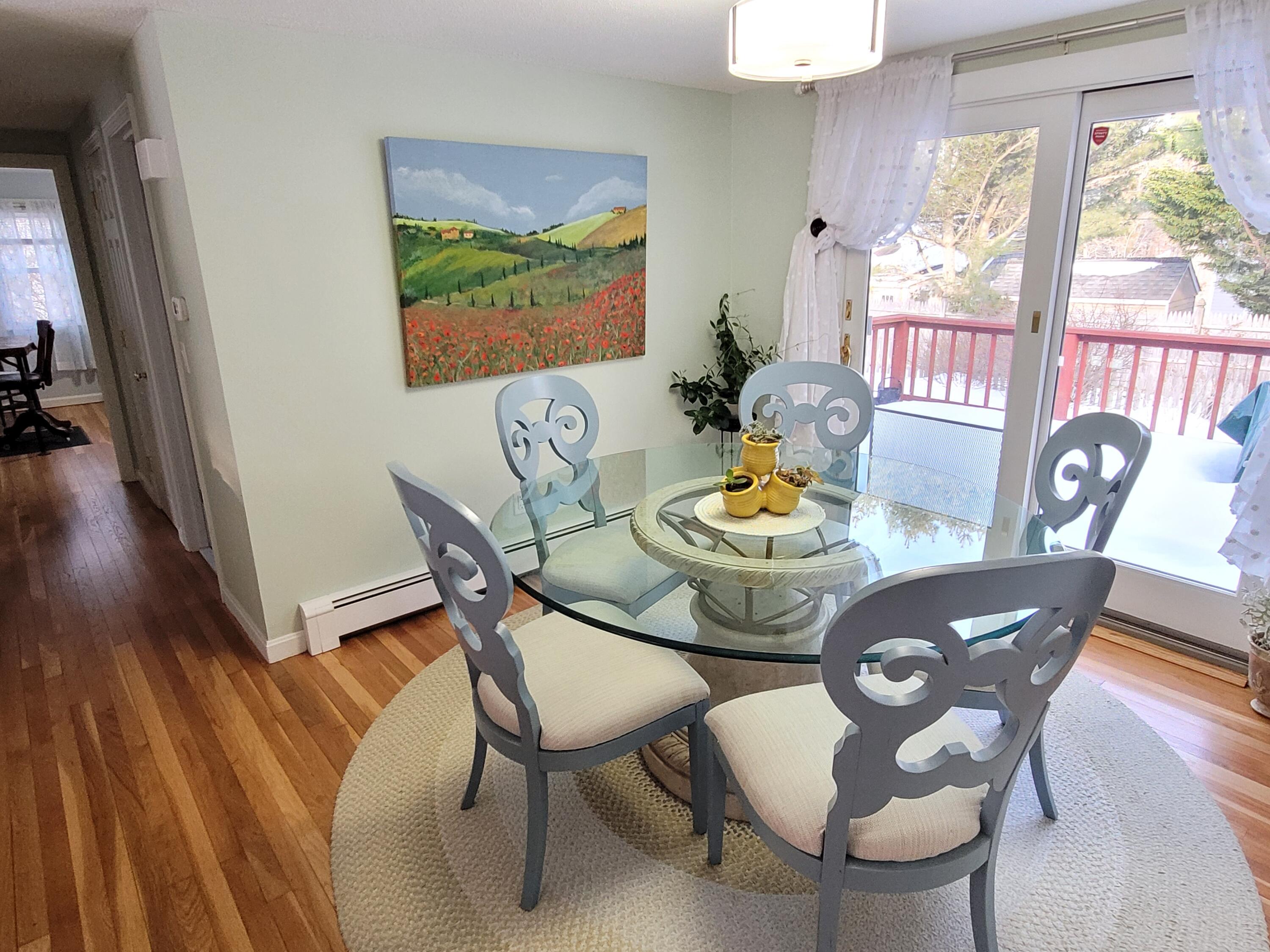 70 Trowbridge Path West Yarmouth, MA 02673 - Photo 37 of 69 a dining room with furniture a large window and wooden floor