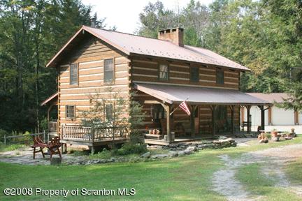193 Elk Lake Road Meshoppen, PA 18630 - Photo 1 of 12 a front view of house with a garden