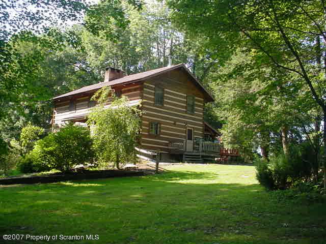 193 Elk Lake Road Meshoppen, PA 18630 - Photo 8 of 12 a view of backyard with a garden and trees