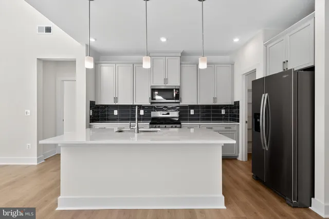 a large kitchen with stainless steel appliances