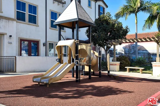 a view of a park with swings and slides