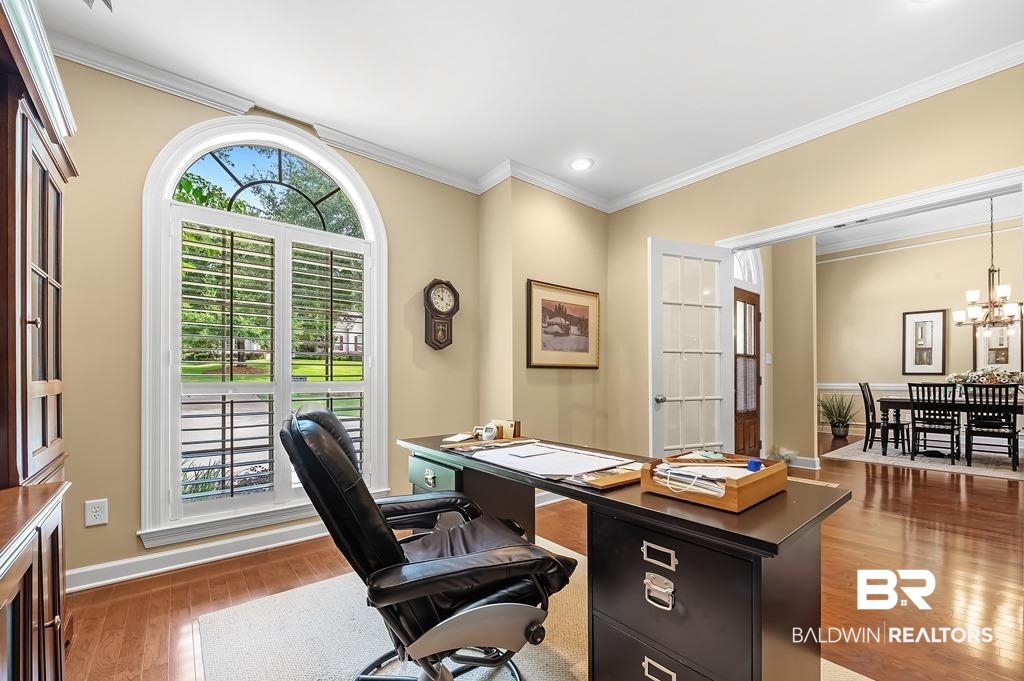 29976 Dolive Ridge Daphne, AL 36527 - Photo 11 of 58 Office space with a healthy amount of sunlight, crown molding, wood-type flooring, and a notable chandelier