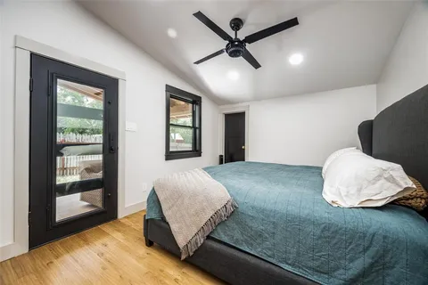 a bedroom with a large bed and a large window