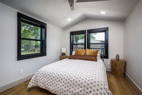 a bedroom with a large bed and a window