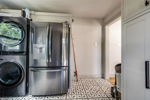 a kitchen with a refrigerator and a stove