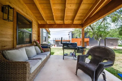 a outdoor living space with furniture and a fireplace