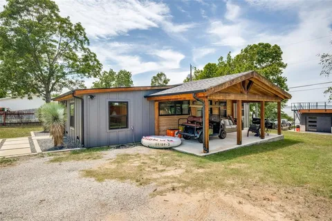 a view of a house with sitting area and garden