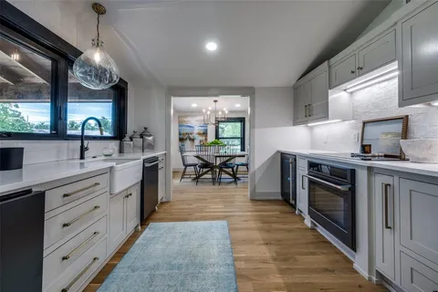 a kitchen with stainless steel appliances granite countertop a stove and a sink