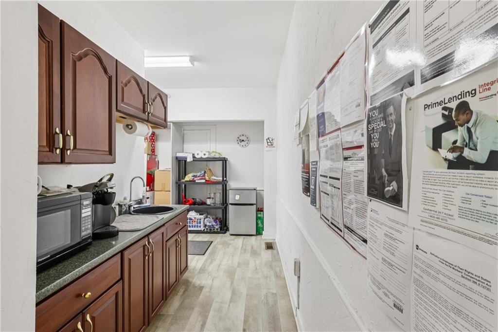 4723 Butler Street Pittsburgh, PA 15201 - Photo 11 of 47 a kitchen with stainless steel appliances a stove a sink and a refrigerator